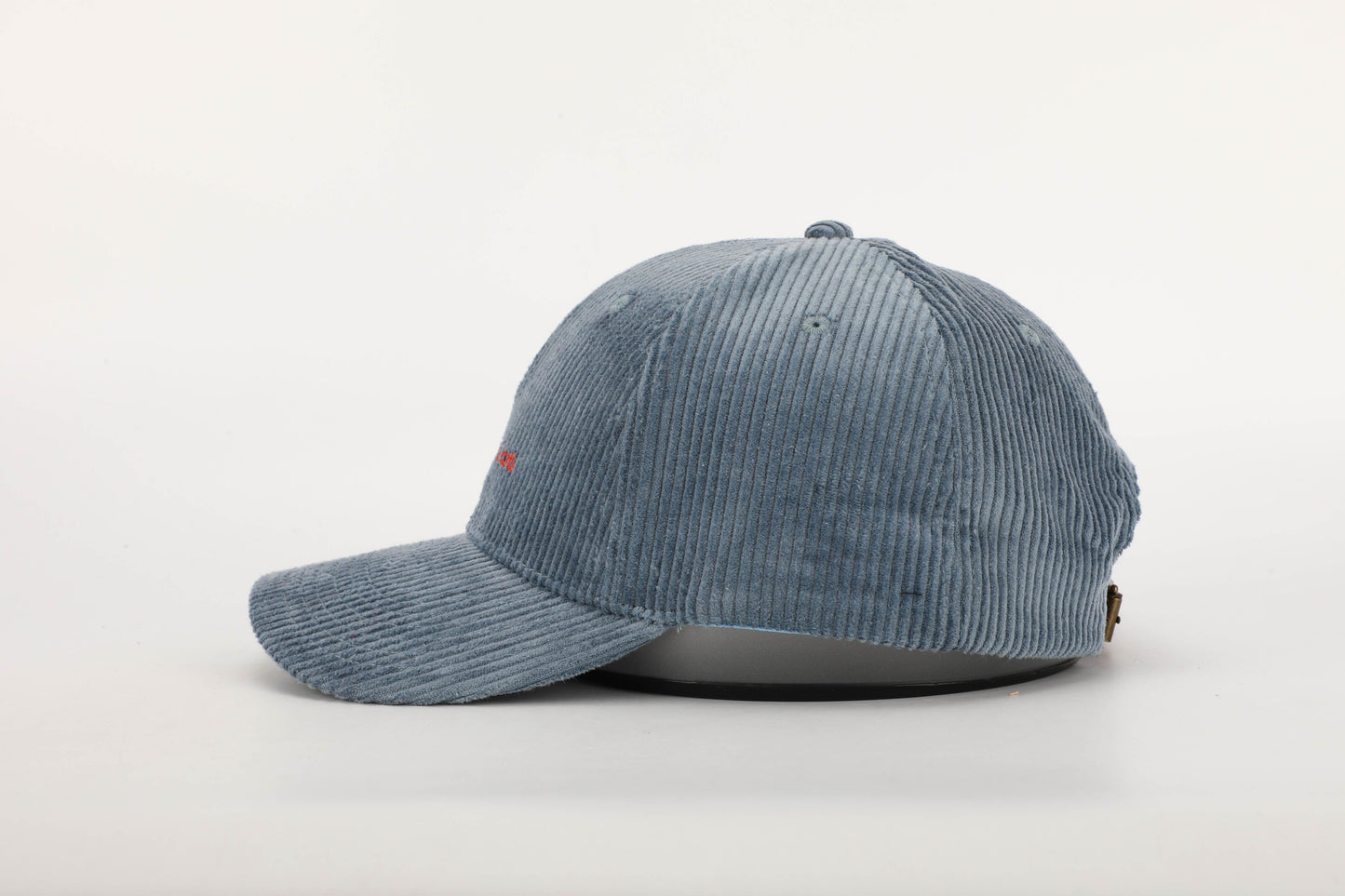 unisex blue corduroy cap orange stitching brown leather buckle strap baseball cap side on
